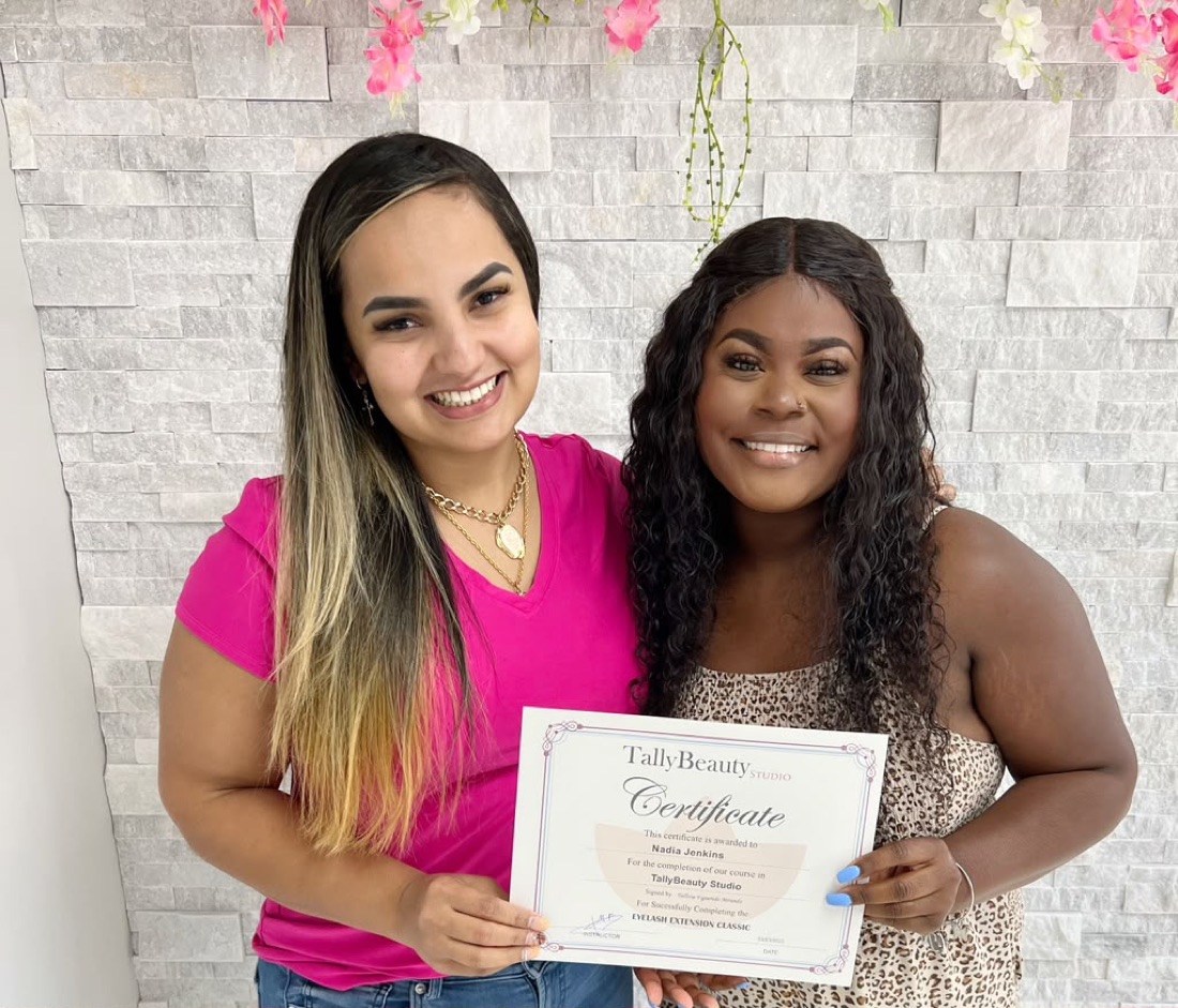 Tally with a student holding her Eyelash Extension Classic certificate at Tally Beauty Studio